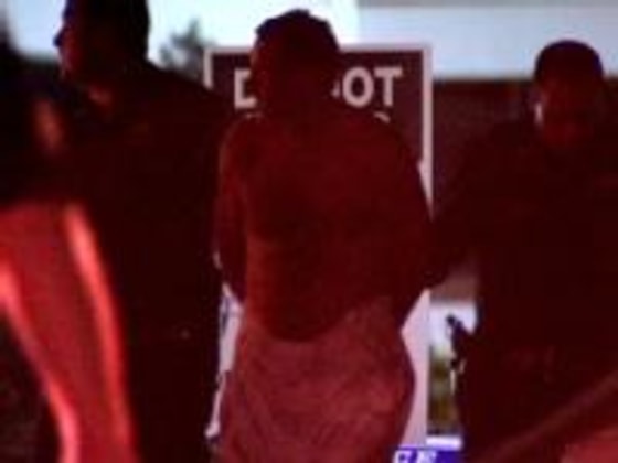 Image: Police lead suspect away